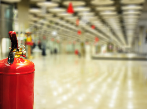 Close up of fire extinguisher in public transportation building / station.