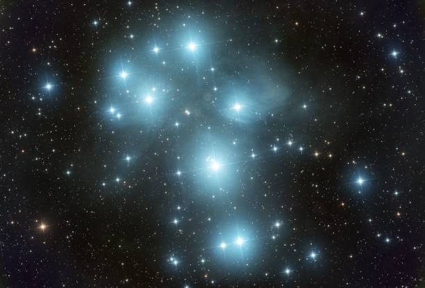 Mesmerizing Pleidies star cluster and reflection nebulosity in the night sky An awe-inspiring image of the Pleiades star cluster and reflection nebulosity illuminated in the night sky, creating a captivating scene the pleiades stock pictures, royalty-free photos & images