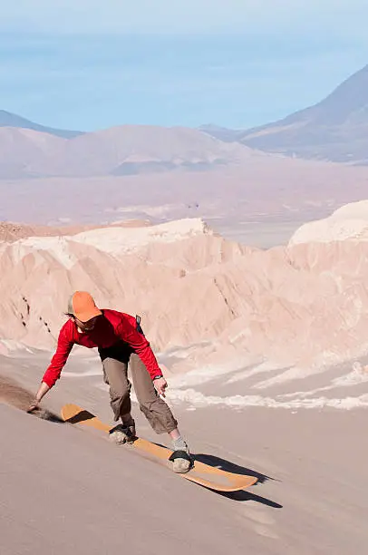Female sandboarding in the desertSandboarding in Chile's Atacama desert's Death Valley