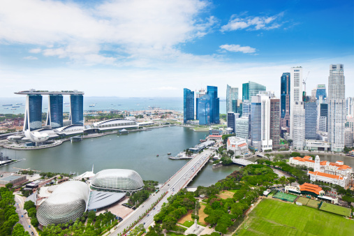 Singapore - Feb 25, 2020. Famous tourist destination - Marina Bay Sands , Shoppes mall, ArtScience museum and Helix bridge in Marina bay, Singapore, on sunny day. Must-see landmarks of city-state, clear blue sky, azure waters. Iconic futuristic architecture and symbols.