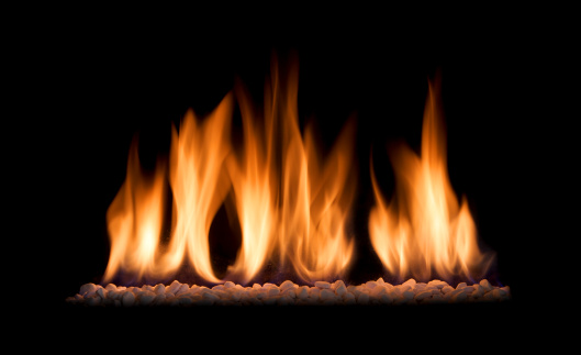 the beautiful flames of a gas fire isolated against a black background. 