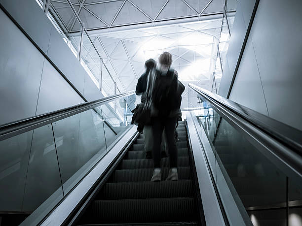 istock People on escalator at airport, London 155379139