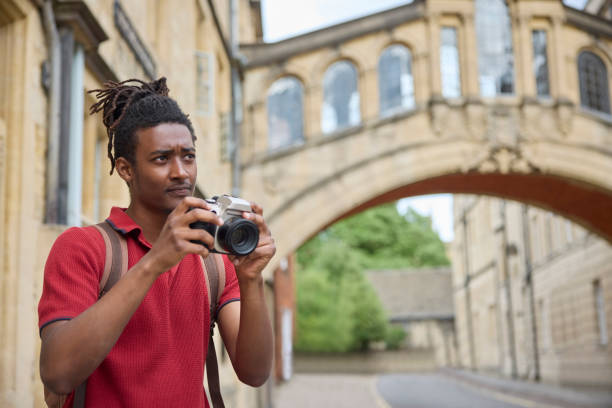 istock Young Man Travelling On Vacation Taking Photo With Camera When Sightseeing In Oxford 1553791763