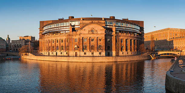Stockholm Riksdaghuset Swedish Parliament at sunset Golden sunlight of sunset illuminating the historic stone and modern glass additions of the Riksdaghuset, home to the Swedish Riksdag parliament flanked by Kungliga Operan, the Royal Swedish Opera, and Kungliga slottet, the Royal Palace, on Helgeandsholmen island in the heart of Stockholm, Sweden's picturesque capital city. ProPhoto RGB profile for maximum color fidelity and gamut. stockholm photos stock pictures, royalty-free photos & images
