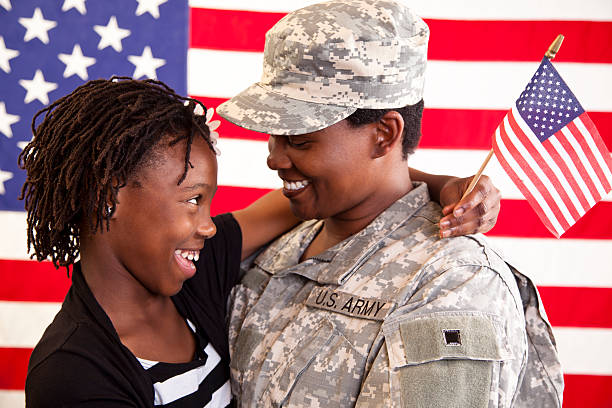 Military mom being welcomed home by daughter. Veteran, USA flag. Military mom being welcomed home by daughter. MORE LIKE THIS... in lightboxes below. proud army mom stock pictures, royalty-free photos & images