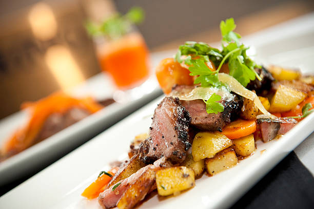 Roasted duck slices served with potatoes and carrots