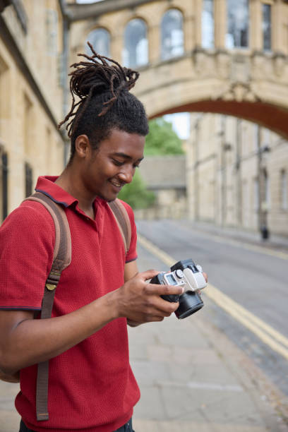 istock Young Man Travelling On Vacation Taking Photo With Camera When Sightseeing In Oxford 1553794272
