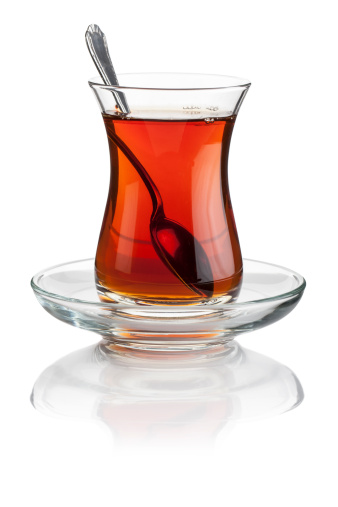 Turkish tea in a cristal Turkish tea glass and silver spoon isolated on white