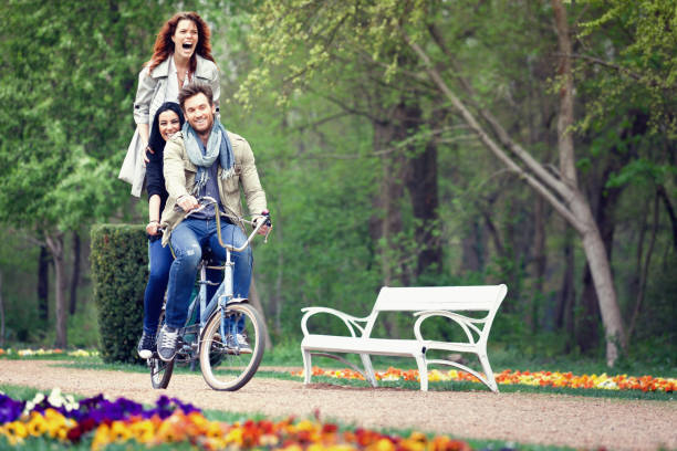 Young couple riding on a bicycle.