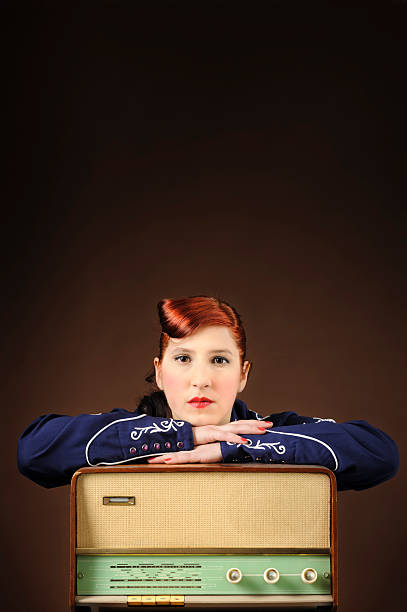 Woman with an old radio, vintage portrait stock photo
