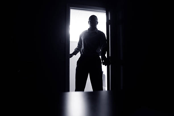 istock haunting office scene; man in doorway silhouetted 155379586
