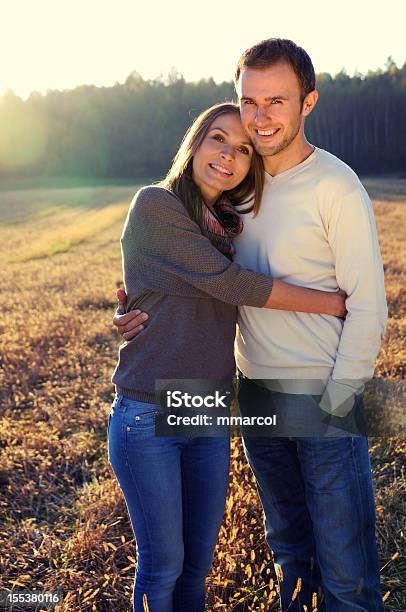 Young Hugging Couple In Fall Stock Photo - Download Image Now - Adults Only, Autumn, Beautiful People