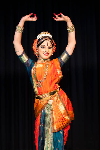 Beautiful Indian Kuchipudi Dancer Performing On Stage Beautiful Indian Kuchipudi Dancer Performing On Stage Wearing Traditional Ornate Costume andJewelry. This is a classical dance from Southern India. bharatanatyam dancing stock pictures, royalty-free photos & images