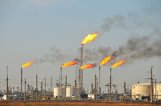 Gas flaring Gas flaring at an oil refinery. oil field stock pictures, royalty-free photos & images