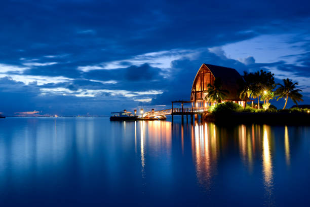 The Tranquil Night and Beautiful Seascape of Maldives Beautiful and tranquil night and seascape of  Maldives beach hut stock pictures, royalty-free photos & images