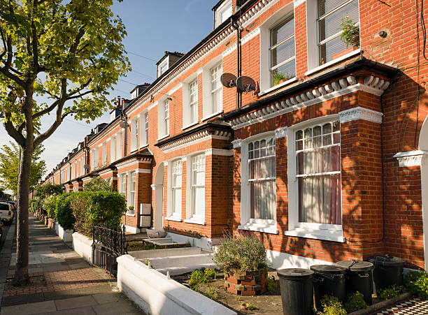 Terraced Houses in South London A long row of Victorian houses in the London Borough of Wandsworth. terraced field stock pictures, royalty-free photos & images