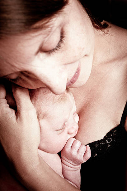 istock Mother Holding Newborn Baby 155380870