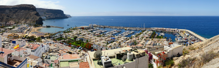 Panorama (of 10 seperate images) of harbor of Puerto de Mogan of Gran Canaria (Canary Islands, Spain) with the sailing boats. All around are small stores and restaurant of the old town part.The town it known as Little Venice\