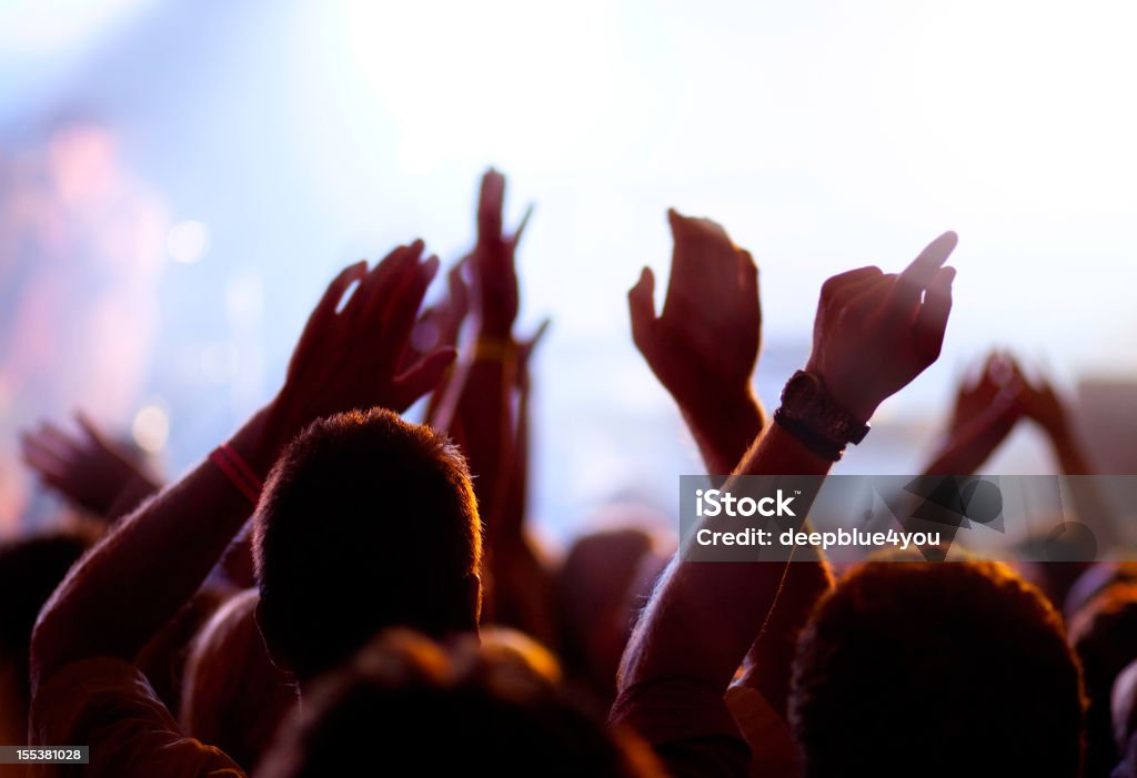 Cheering and watching crowd, blurred motion. Cheering and watching crowd, high iso, blurred motion. Exhilaration Stock Photo