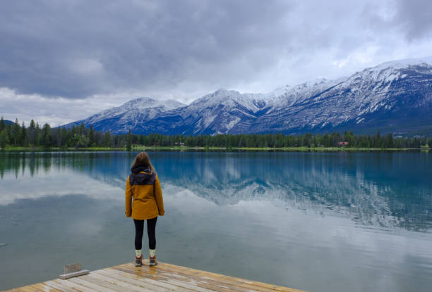 istock Woman on Lake Edith, Jasper National Park, Canada 1553810450
