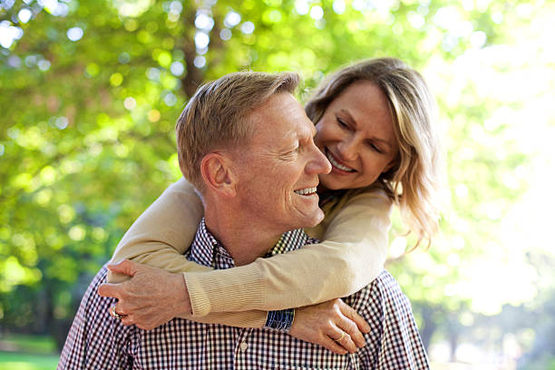 istock Man carrying his wife on piggy back 155381050
