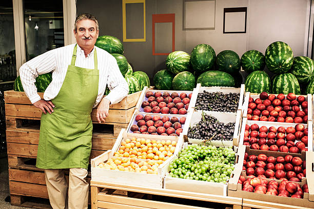 Small Business Owner  In Greengrocer'S Shop Looking At Camera.