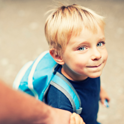 Little boy with backpack on his way to school / kindergarten.