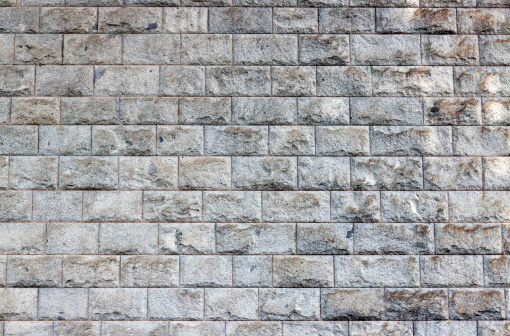 Large granite bricks wall, full frame horizontal composition with copy space