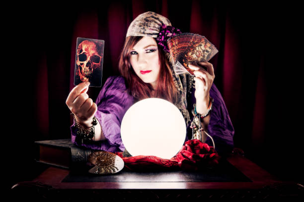 istock Fortune Teller Holding Skull Tarot Card 155381289