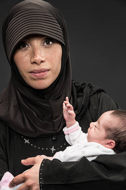 istock Muslim woman with her newborn daughter 155381455