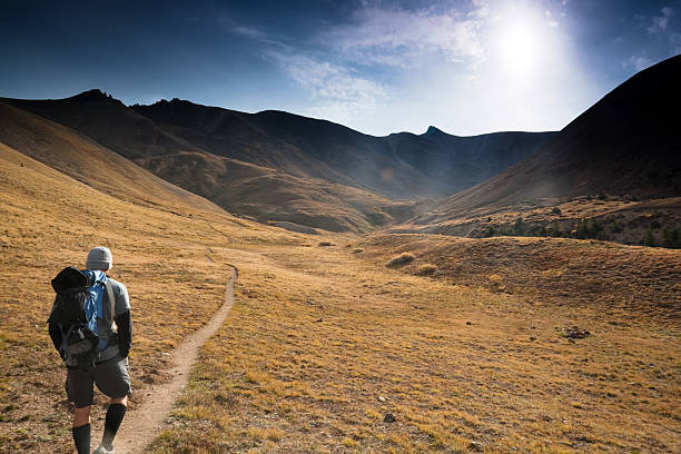 istock mountain man hiking sunshine landscape 155381813