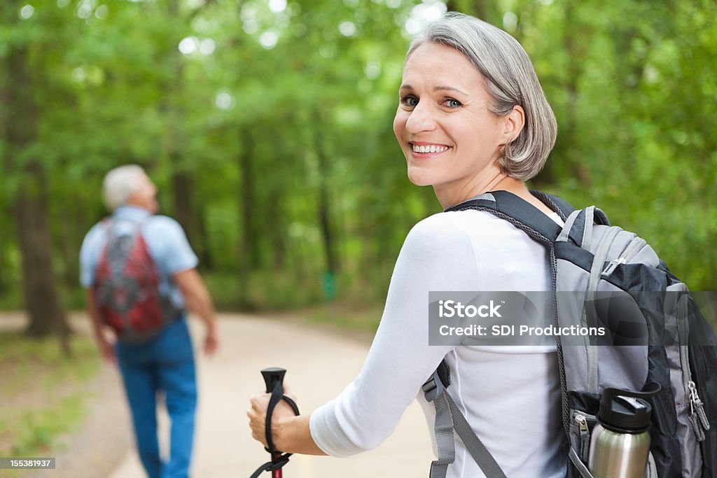 Happy senior woman hiking with husband Happy senior woman hiking with husband.  Hiking Stock Photo