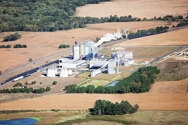 Ethanol Biorefinery Fall Aerial with Farmland An aerial view of an Ethanol plant, surrounded by farms and cornfields. Shot from the open window of a small airplane on an early autumn day.   http://www.banksphotos.com/LightboxBanners/Aerial.jpg corn biodiesel crop corn crop stock pictures, royalty-free photos & images