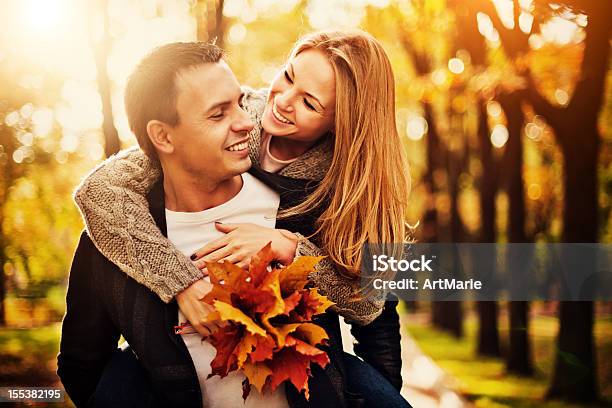 Happy Young Couple In Autumn Park Stock Photo - Download Image Now - Autumn, Couple - Relationship, Beauty