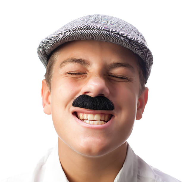 Young Italian Boy Making a Face with Mustaches and Coppola stock photo