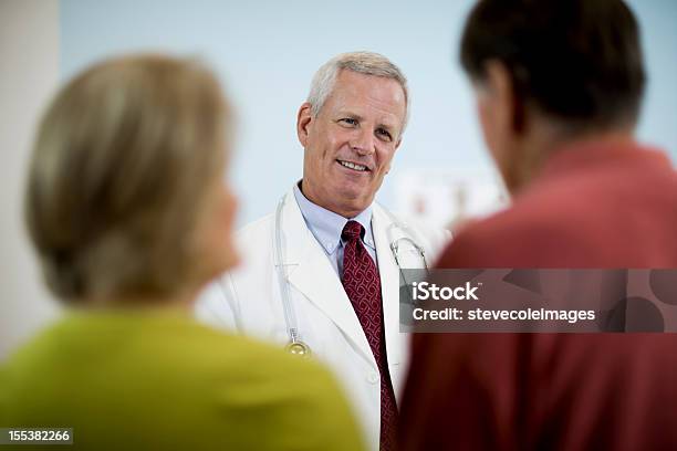 Médico Explicando Medical Resultados Para Parejas Foto de stock y más banco de imágenes de 50-59 años - 50-59 años, 55-59 años, 70-79 años