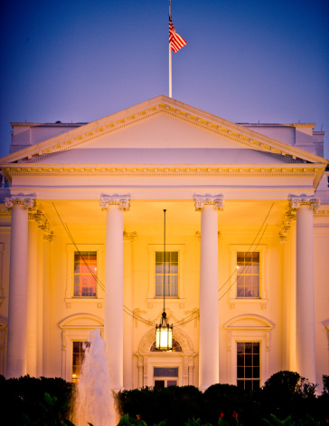 The White House lit up at night in Washington DC, USA.