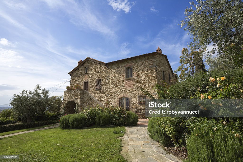 Tuscany, next to Florence: typical farmhouse and its garden Ancient renovated farmhouse typical of Tuscany, Italy, and its beautiful garden Farmhouse Stock Photo