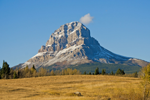 The rocky Crowsnest Mountain in the Southern Alberta Rocky Mountains in October with a small 