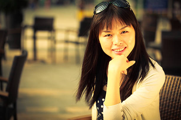 istock Beautiful young Asian woman smiling at cafe 155382942