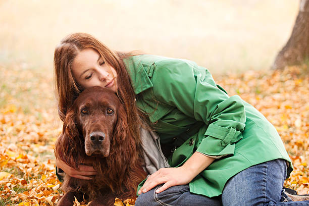 istock Red Haired Woman Embracing & Loving Irish Setter Dog 155382980
