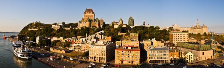 Early morning light is reflected off the buildings of the skyline of Vieux-Quebec in this panoramic image.  This photograph was taken from the unique vantage point of the top deck of a large cruise ship.  It is composed of twelve individual images stitched together.