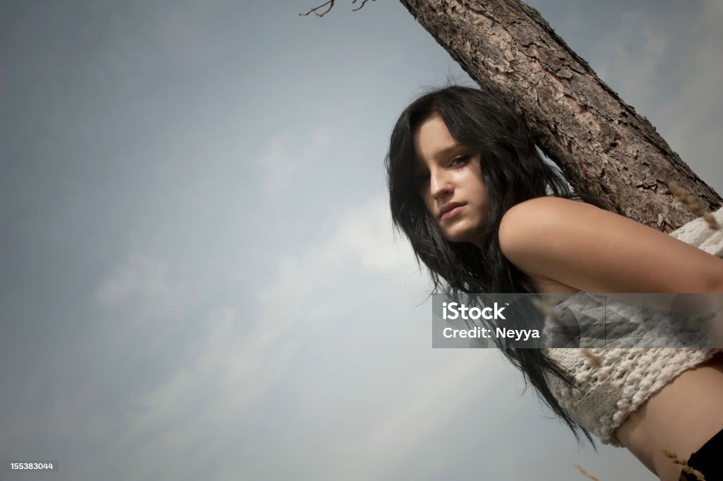 Strapped Woman strapped at a pine tree. 20-29 Years Stock Photo