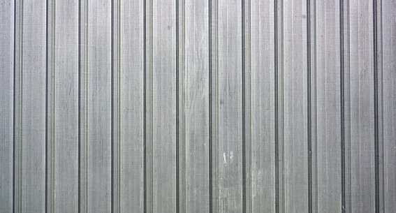 A corrugated metal sheet texture background with vertical stripes, for backgrounds and textures.