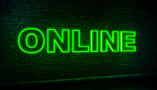 Online neon sign. Brick wall at night with the word Online in green neon letters. Social media, internet, e-commerce, hashtag, online business, influencer, blogging, internet. 3D illustration
