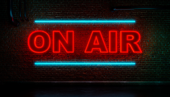 On Air neon sign. Brick wall at night with the word On Air in red neon letters.  TV, broadcasting, radio, television, breaking news, live, entertainment, warning sign, recording studio,  3D illustration