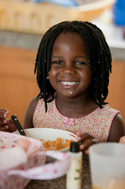Girl, 5 years old, eating corn flakes
