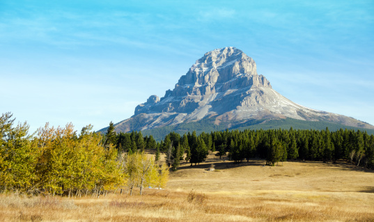 The rocky Crowsnest Mountain in the Southern Alberta Rocky Mountains in October with a small 