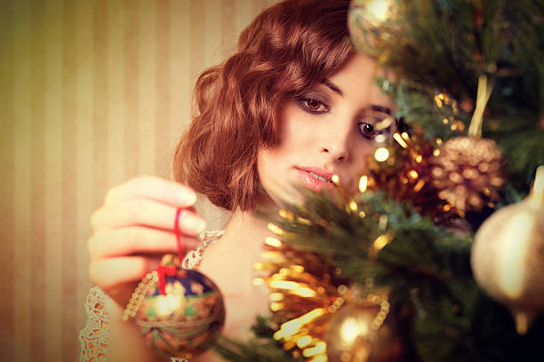 istock retro girl decorating a christmas tree 155383602