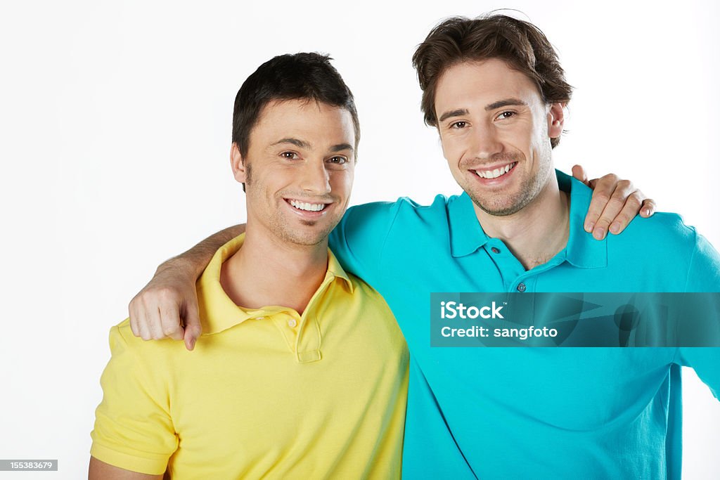 Two friends smiling hands on shoulders Two friends smiling hands on shoulders. 20-29 Years Stock Photo